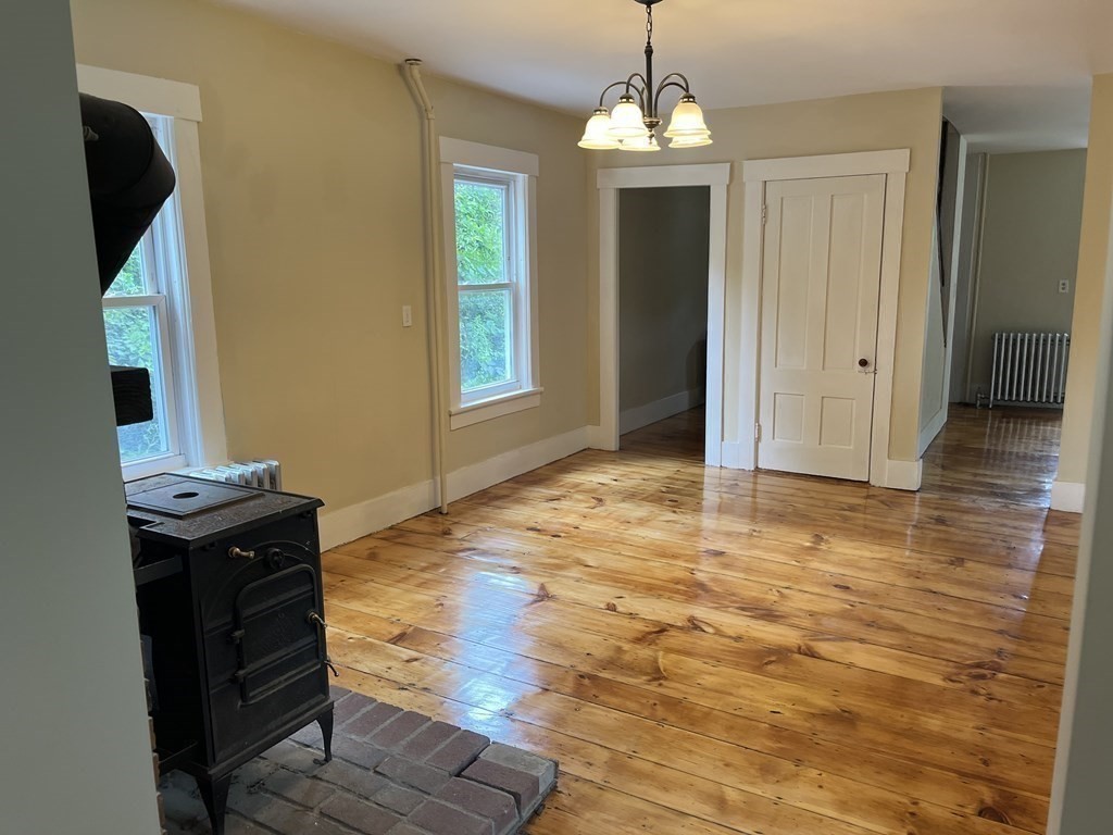 634 Patriots Road Templeton, MA 01468 - Photo 14 of 26 a view of livingroom with chandelier and wooden floor