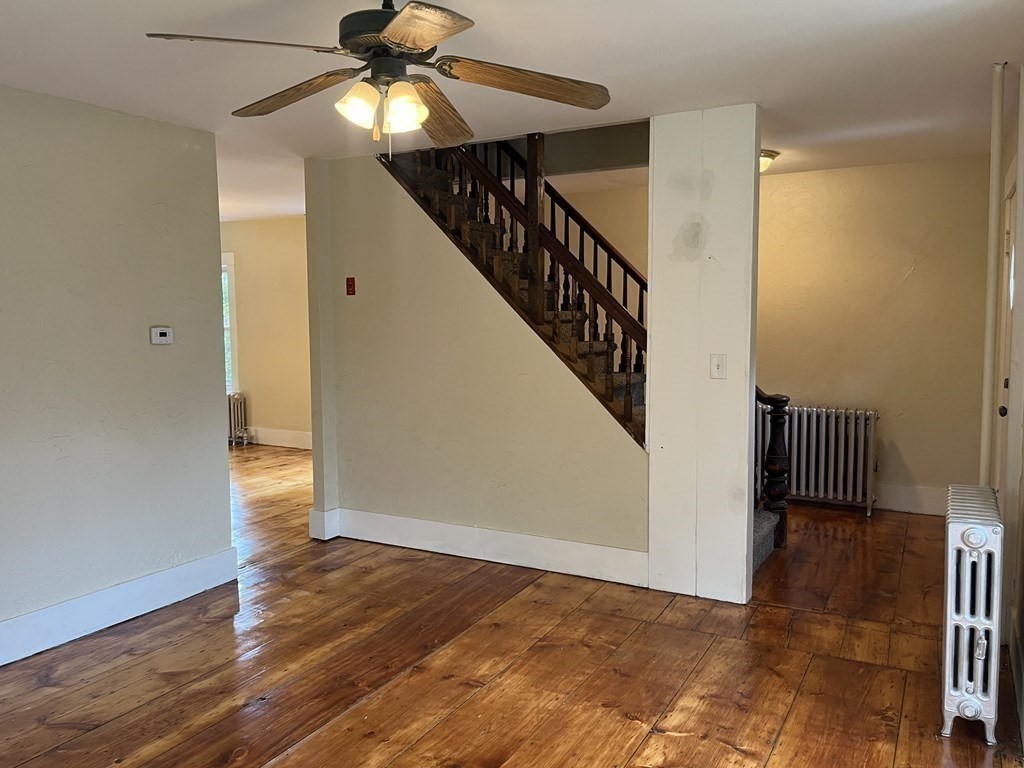 634 Patriots Road Templeton, MA 01468 - Photo 17 of 26 a view of a hallway with wooden floor and staircase