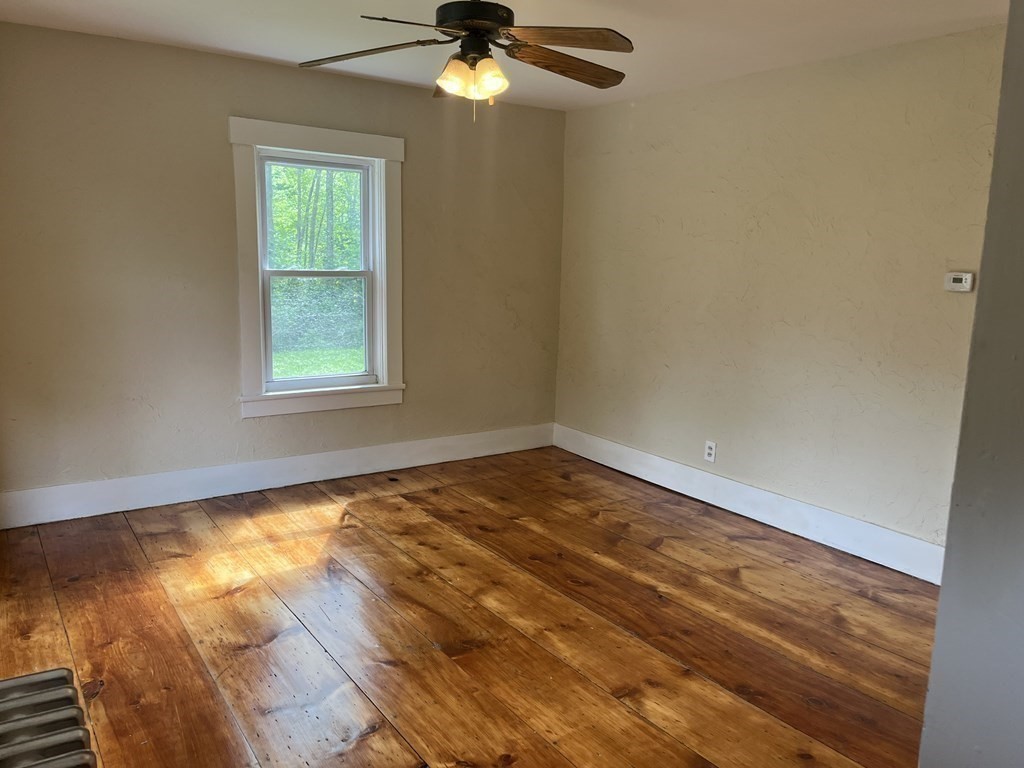 634 Patriots Road Templeton, MA 01468 - Photo 18 of 26 an empty room with a window
