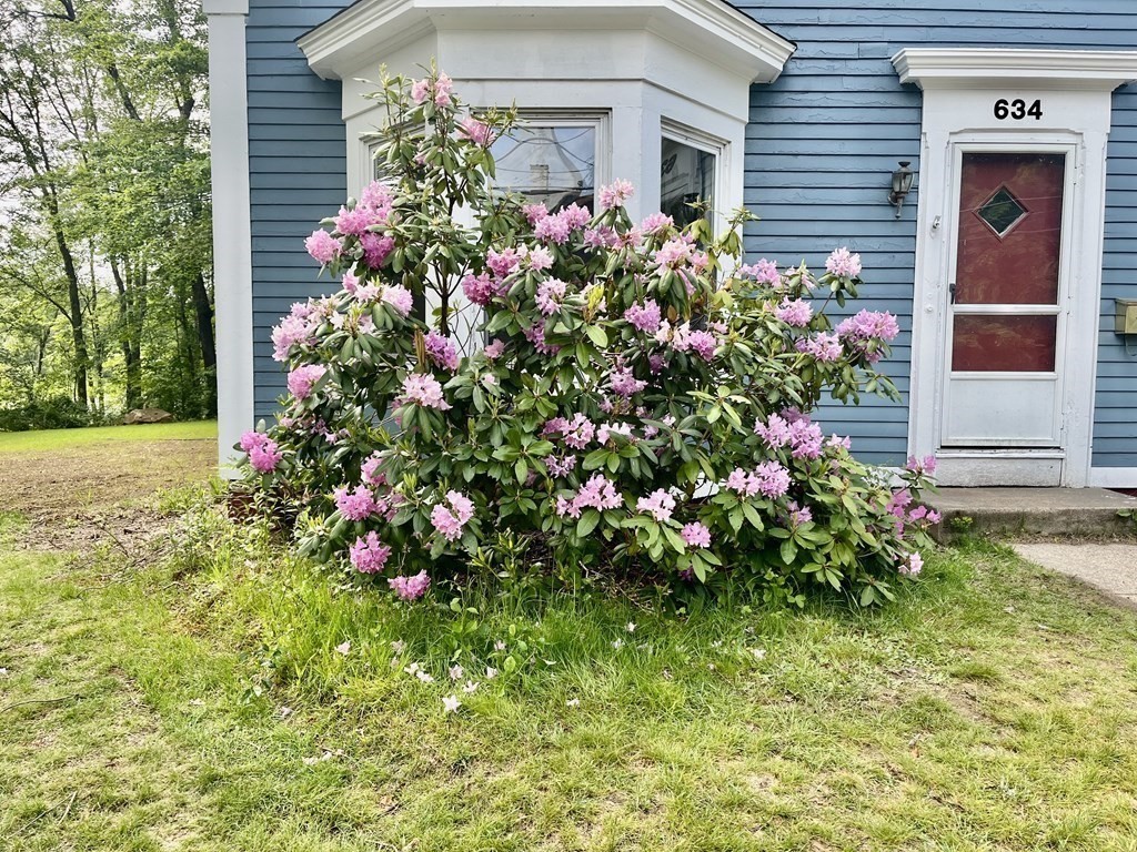 634 Patriots Road Templeton, MA 01468 - Photo 2 of 26 a flower garden in front of the house