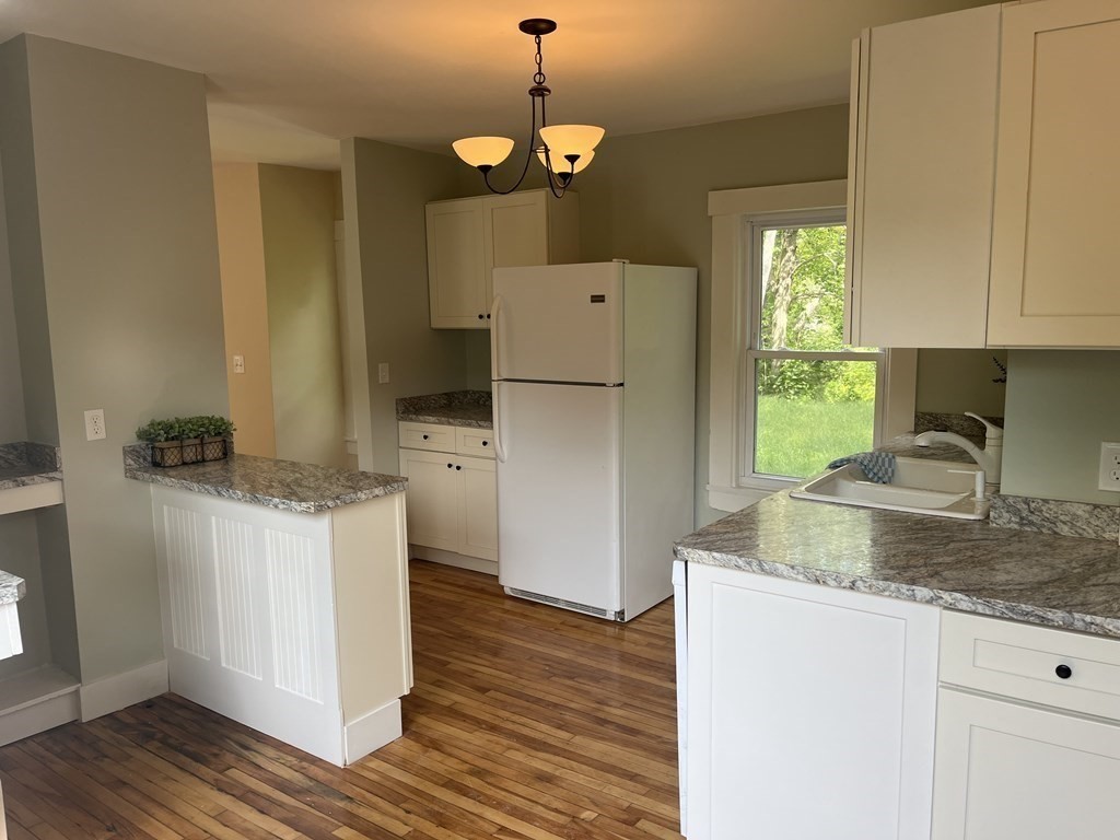 634 Patriots Road Templeton, MA 01468 - Photo 3 of 26 a kitchen with a sink cabinets and wooden floor