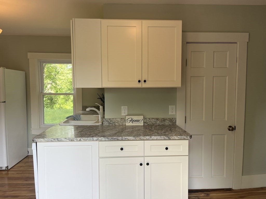 634 Patriots Road Templeton, MA 01468 - Photo 4 of 26 a kitchen with granite countertop white cabinets and window