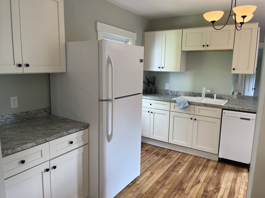 634 Patriots Road Templeton, MA 01468 - Photo 5 of 26 a kitchen with white cabinets and white appliances
