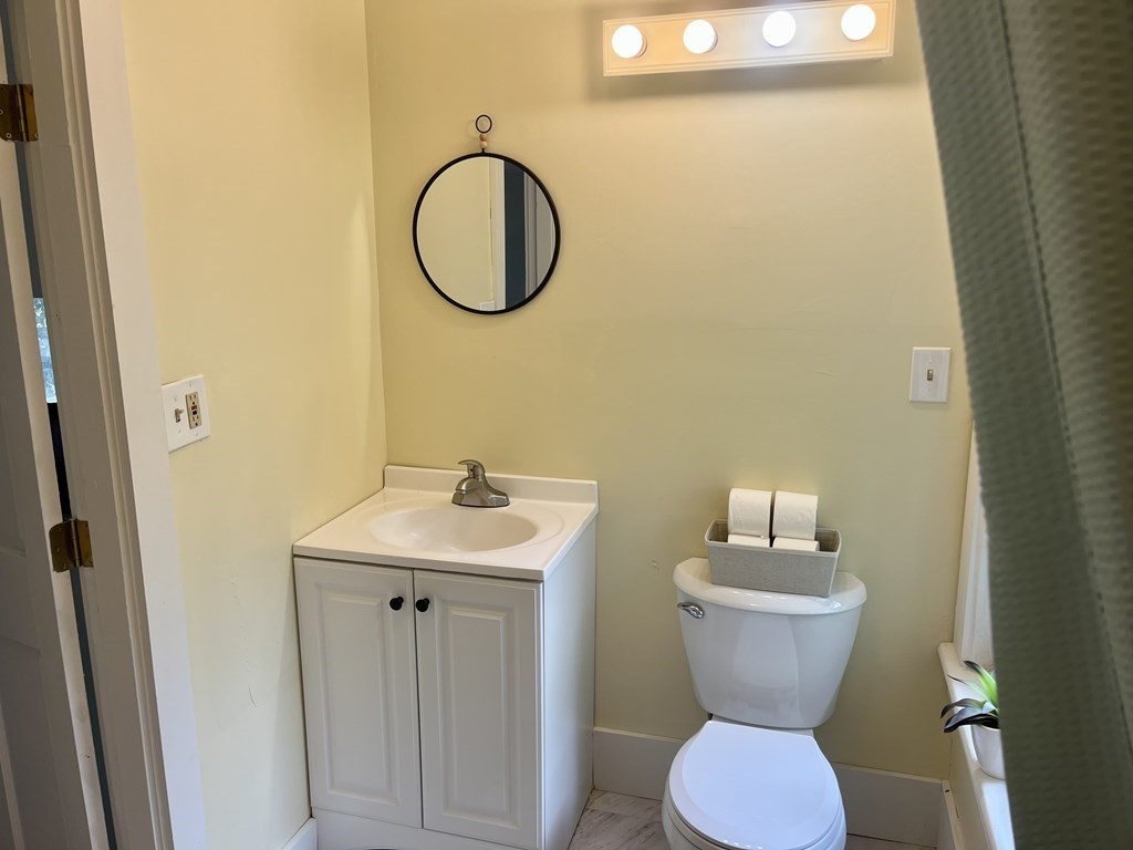 634 Patriots Road Templeton, MA 01468 - Photo 9 of 26 a bathroom with a toilet sink and mirror