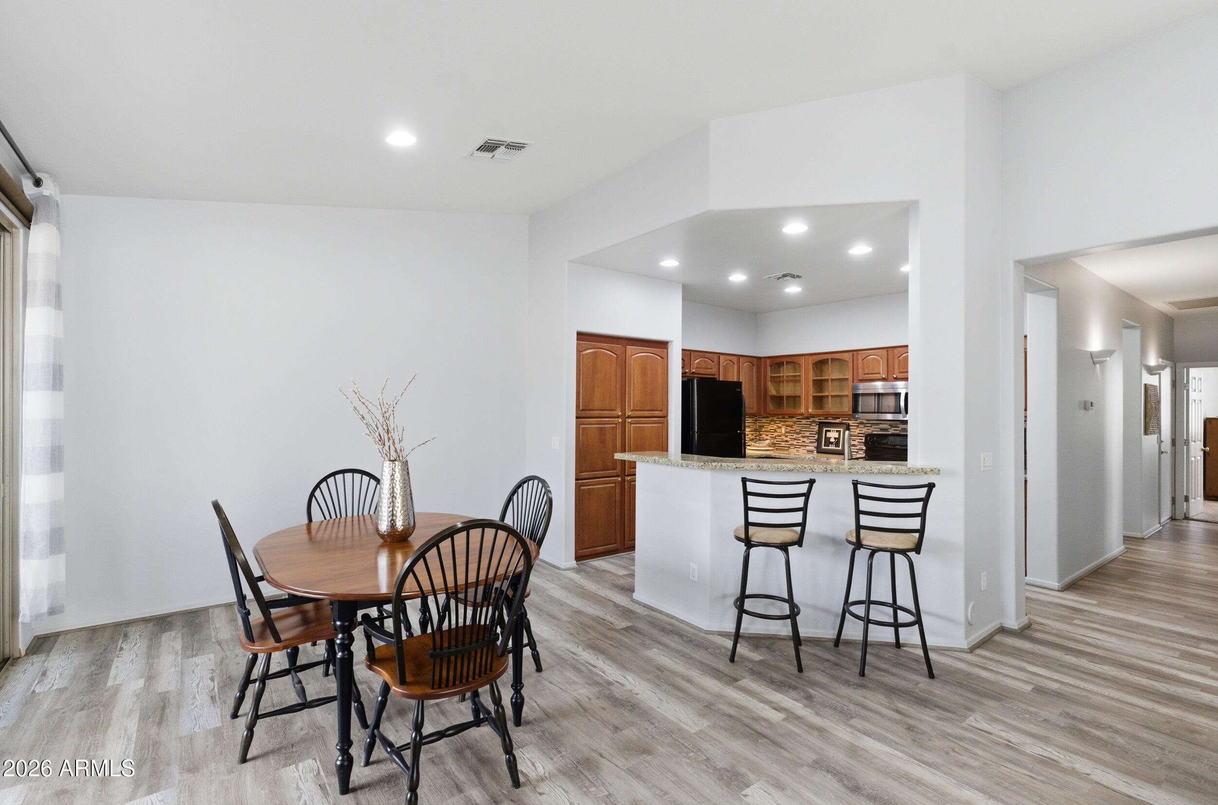 1024 East Frye Road, Unit 1060 Phoenix, AZ 85048 - Photo 5 of 41 a view of a dining room with furniture and wooden floor