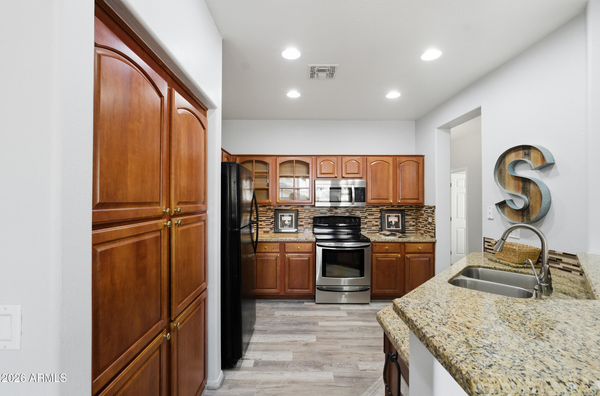 1024 East Frye Road, Unit 1060 Phoenix, AZ 85048 - Photo 8 of 41 a kitchen with stainless steel appliances granite countertop a refrigerator and a stove top oven