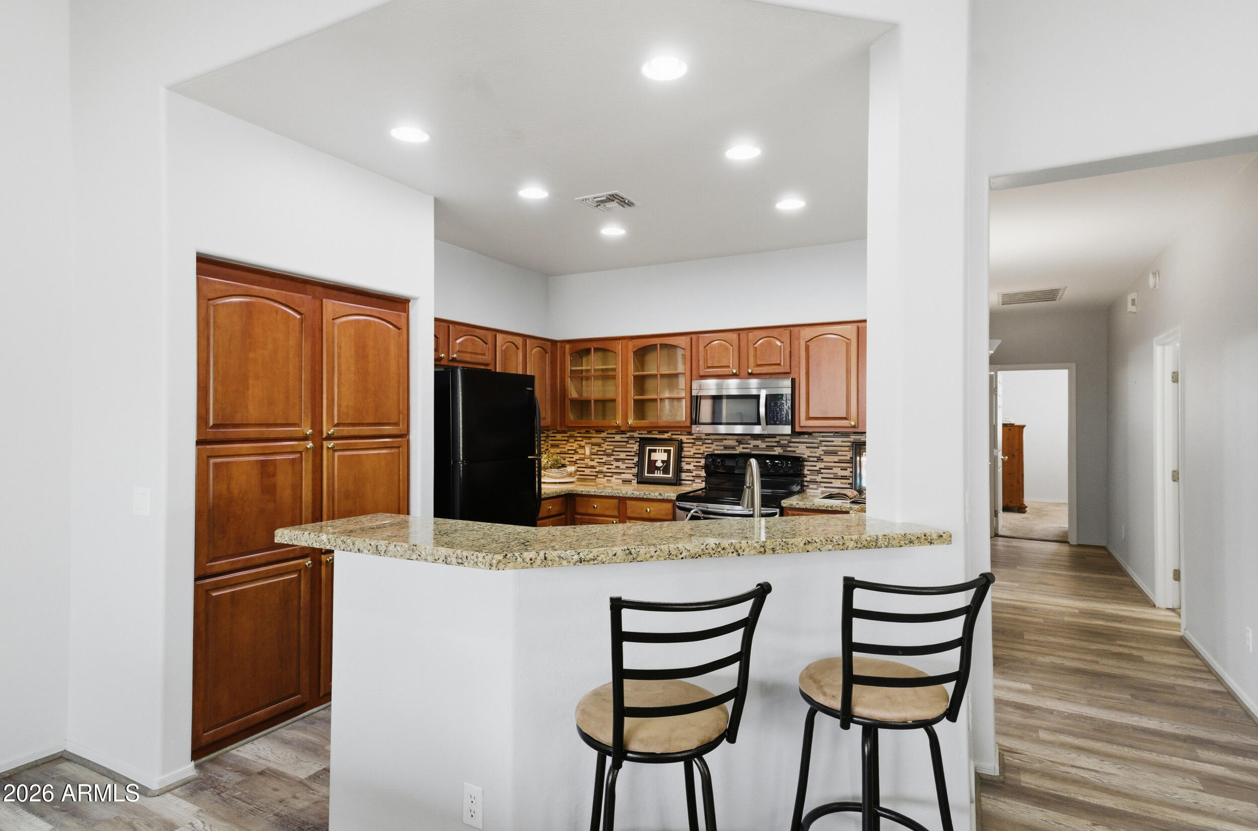1024 East Frye Road, Unit 1060 Phoenix, AZ 85048 - Photo 9 of 41 a kitchen with stainless steel appliances kitchen island granite countertop a refrigerator and microwave