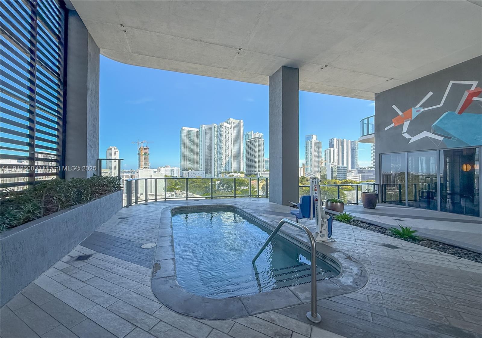 121 Northeast 34th Street, Unit 2003 Miami, FL 33137 - Photo 17 of 27 a swimming pool with outdoor seating and yard