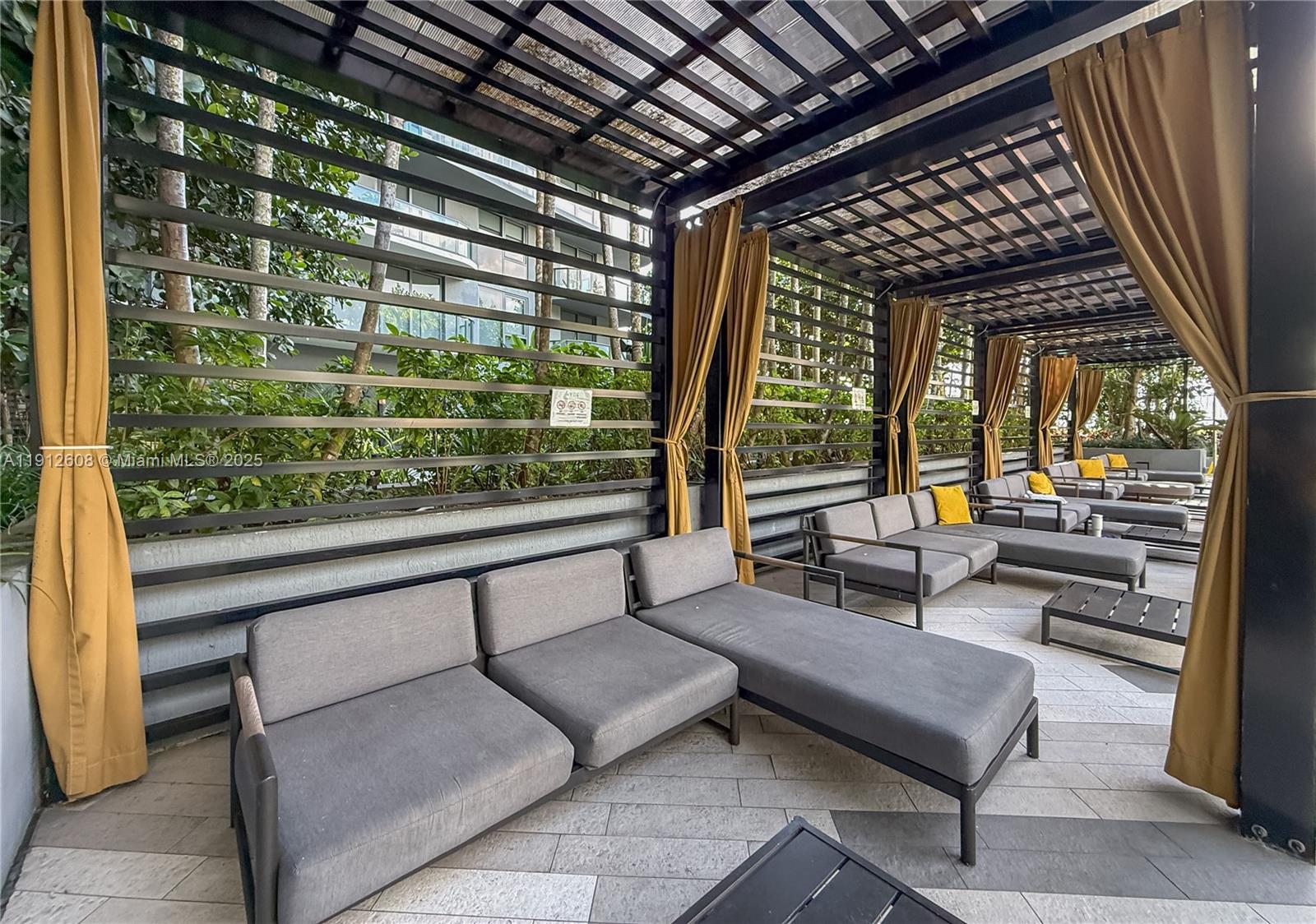 121 Northeast 34th Street, Unit 2003 Miami, FL 33137 - Photo 18 of 27 a outdoor living space with patio furniture and a potted plant