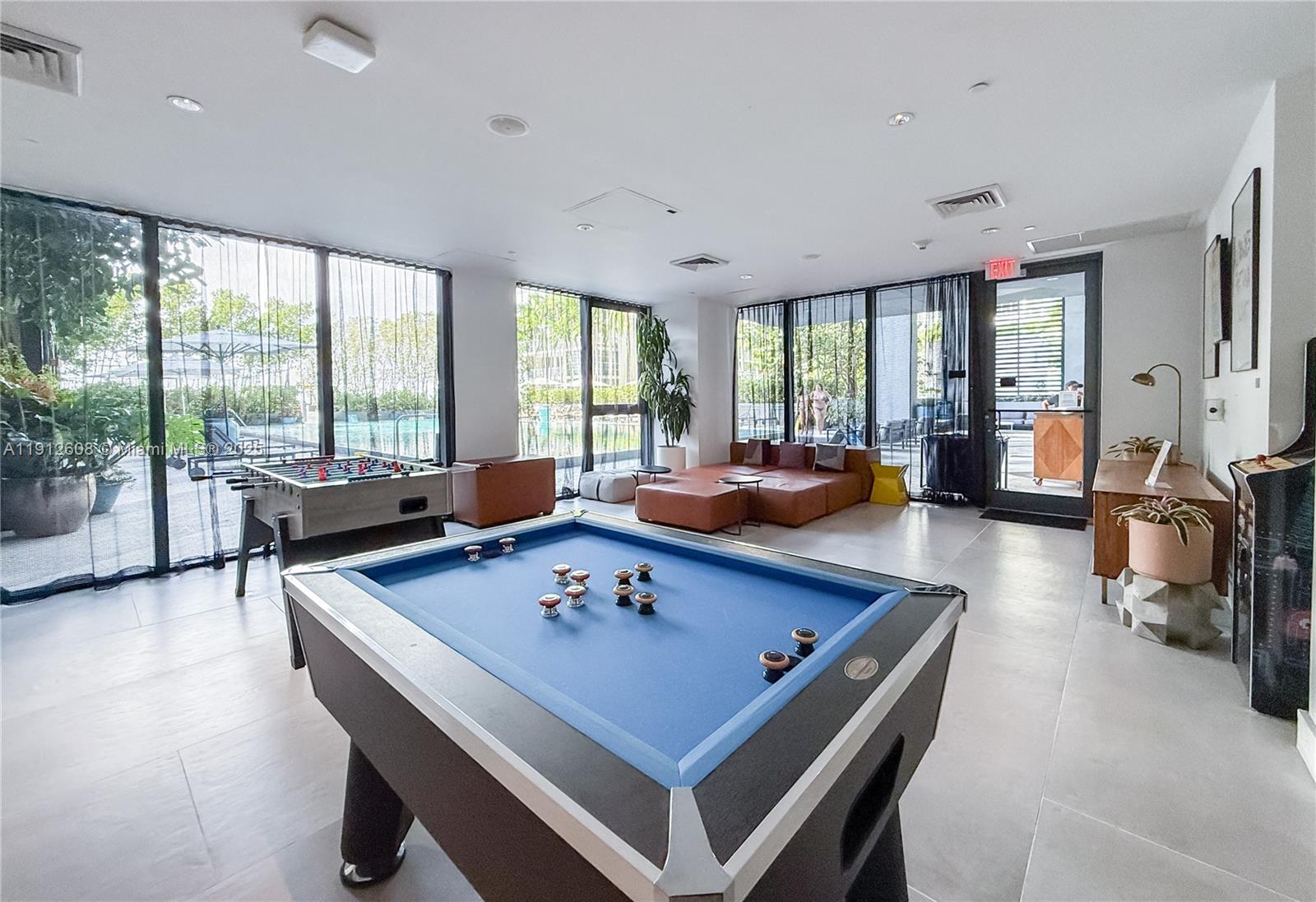 121 Northeast 34th Street, Unit 2003 Miami, FL 33137 - Photo 24 of 27 a living room with furniture and a large window