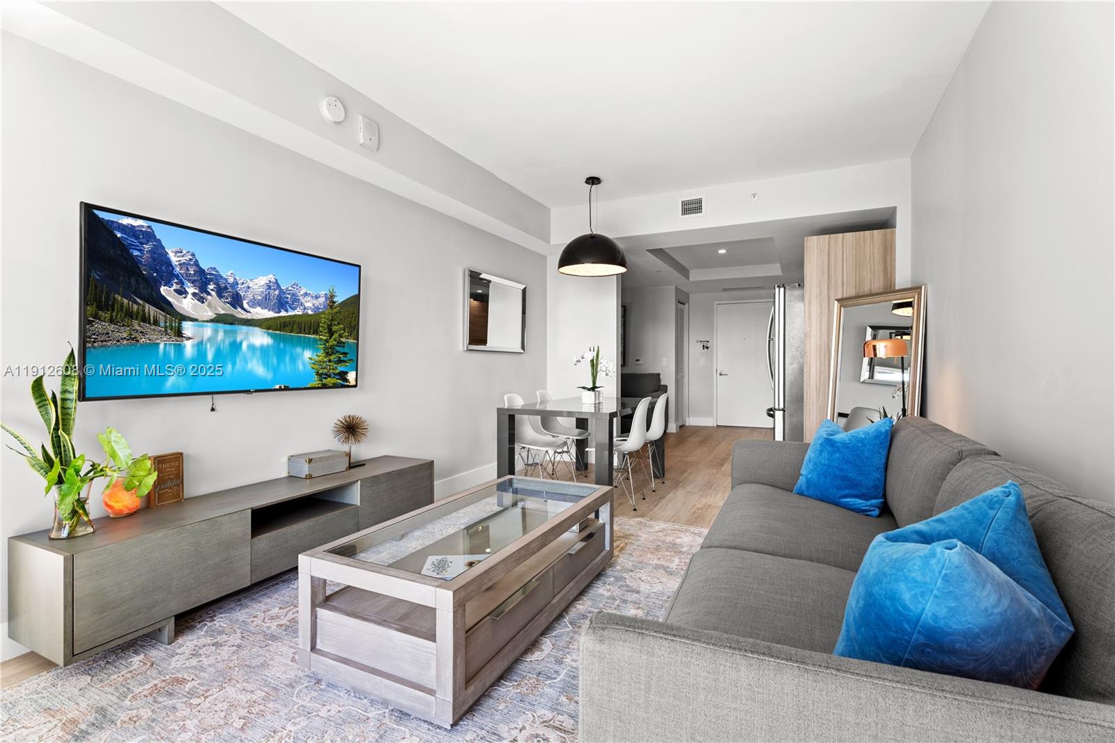 121 Northeast 34th Street, Unit 2003 Miami, FL 33137 - Photo 9 of 27 a living room with furniture and a flat screen tv