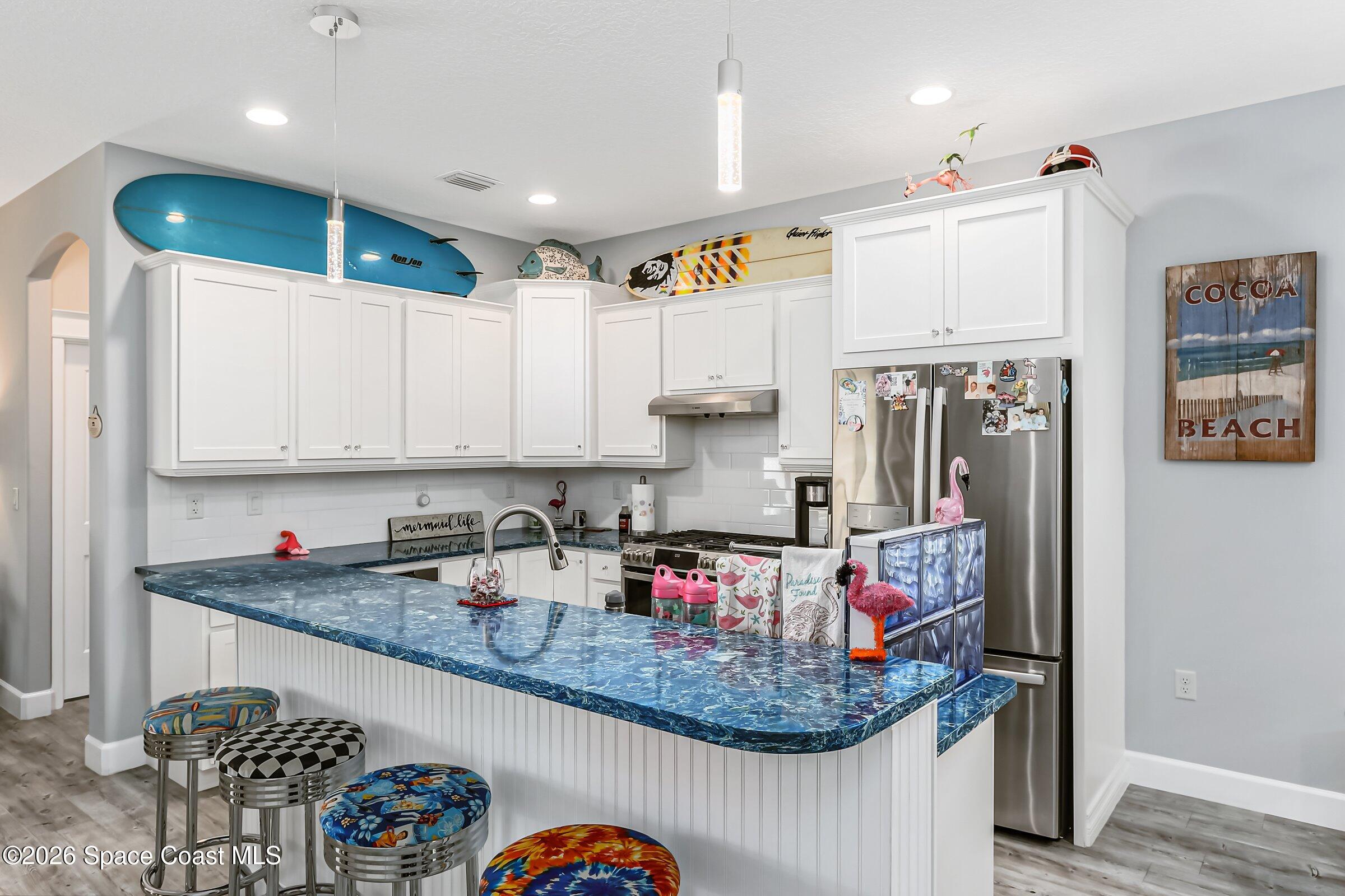 1399 Tullagee Avenue Melbourne, FL 32940 - Photo 11 of 53 a kitchen with stainless steel appliances granite countertop a sink refrigerator and cabinets