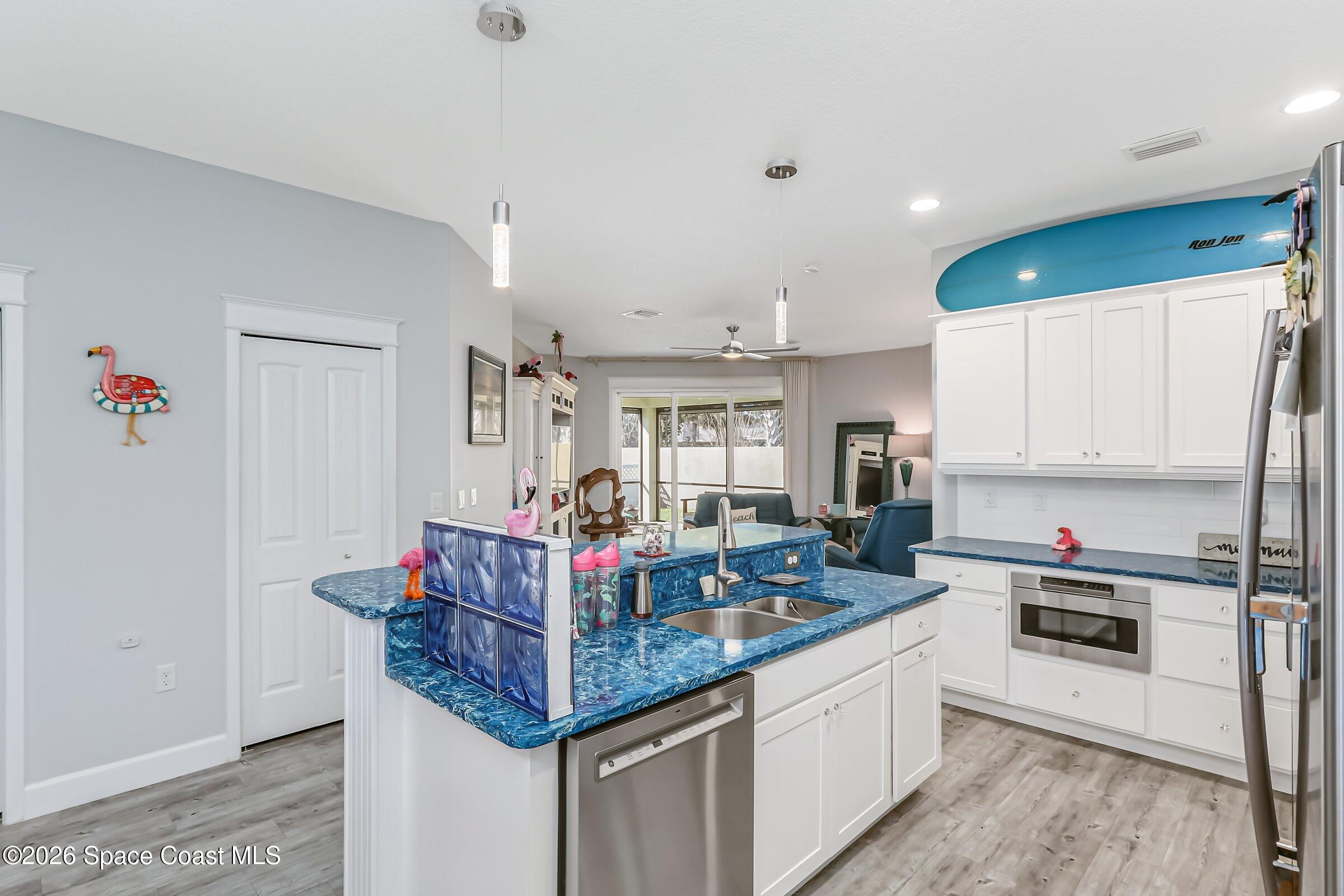 1399 Tullagee Avenue Melbourne, FL 32940 - Photo 13 of 53 a kitchen with granite countertop a sink cabinets and stainless steel appliances