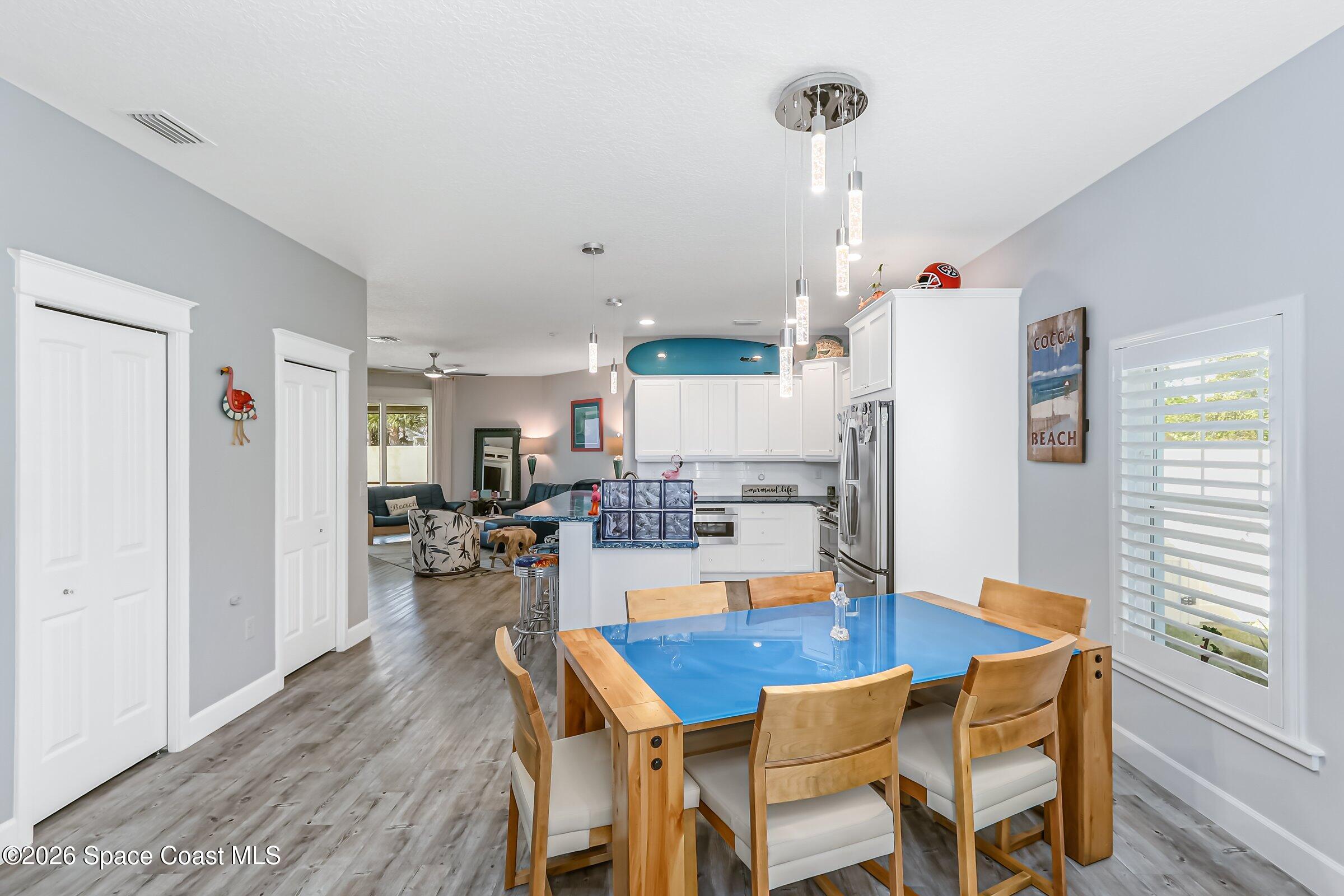 1399 Tullagee Avenue Melbourne, FL 32940 - Photo 15 of 53 a dining room with furniture and wooden floor