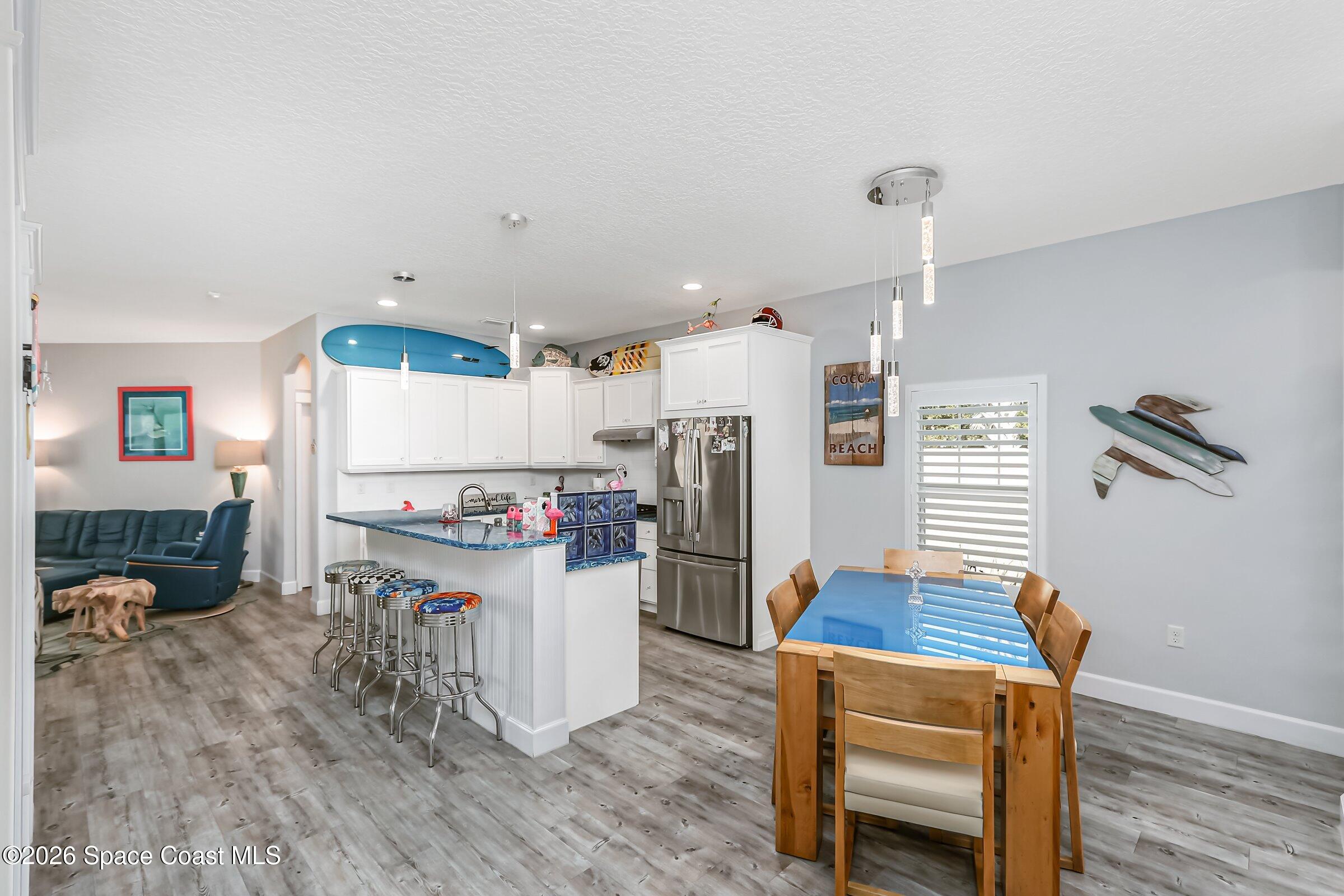 1399 Tullagee Avenue Melbourne, FL 32940 - Photo 17 of 53 a kitchen with refrigerator and microwave