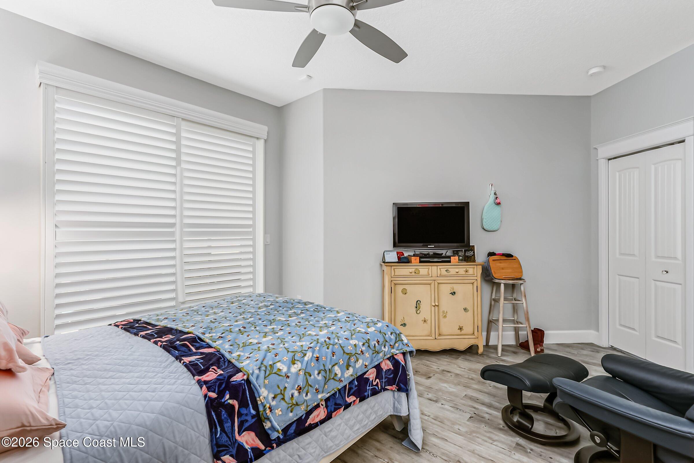 1399 Tullagee Avenue Melbourne, FL 32940 - Photo 18 of 53 a bedroom with a bed and a flat screen tv