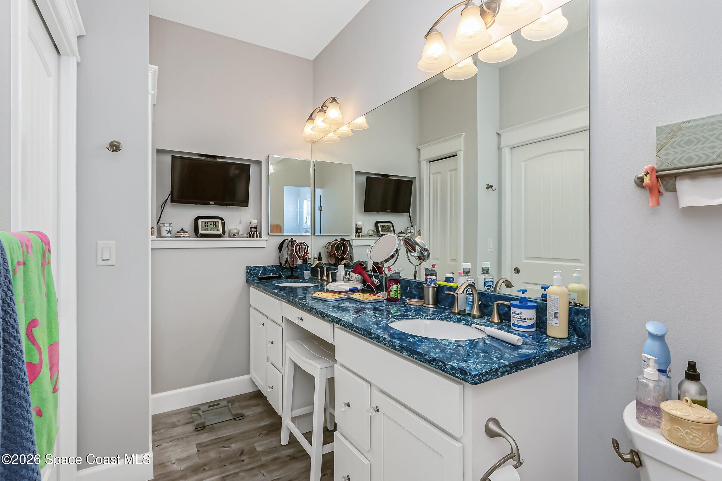 1399 Tullagee Avenue Melbourne, FL 32940 - Photo 21 of 53 a kitchen with kitchen island granite countertop a sink appliances and cabinets
