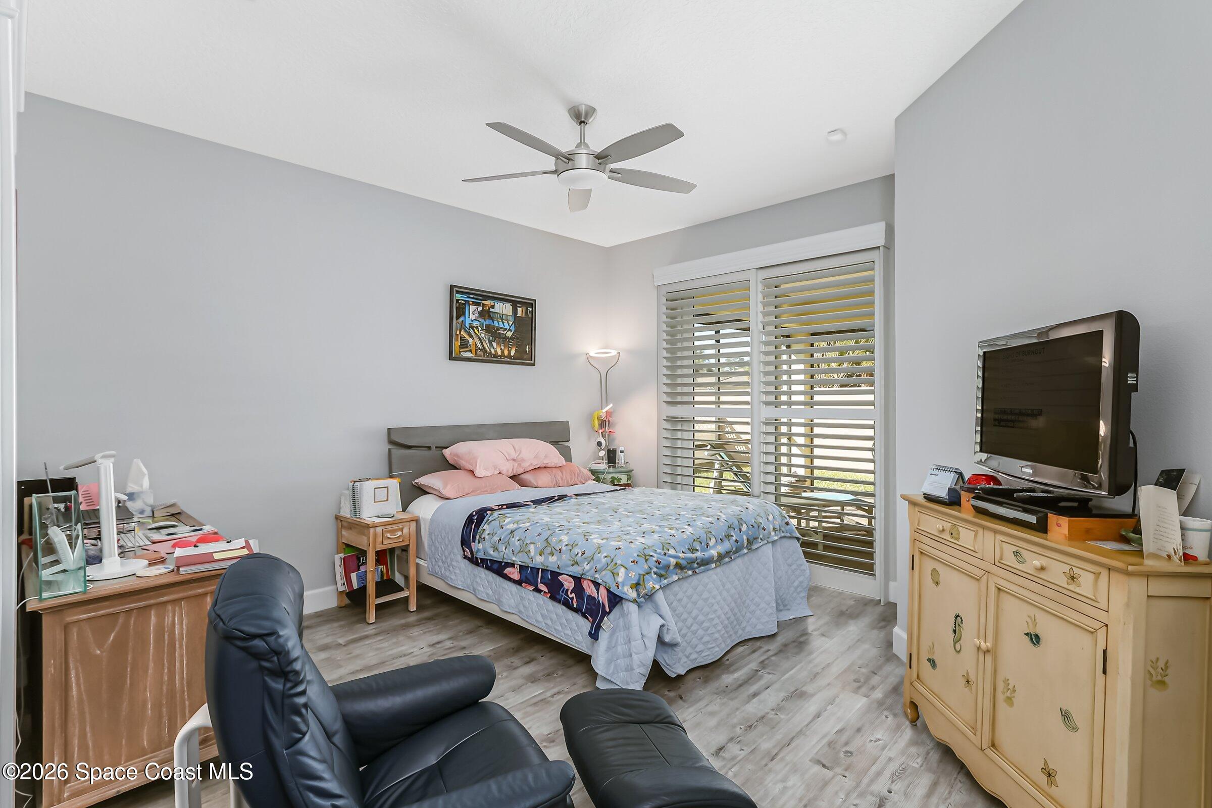 1399 Tullagee Avenue Melbourne, FL 32940 - Photo 22 of 53 a bedroom with a bed and a flat screen tv