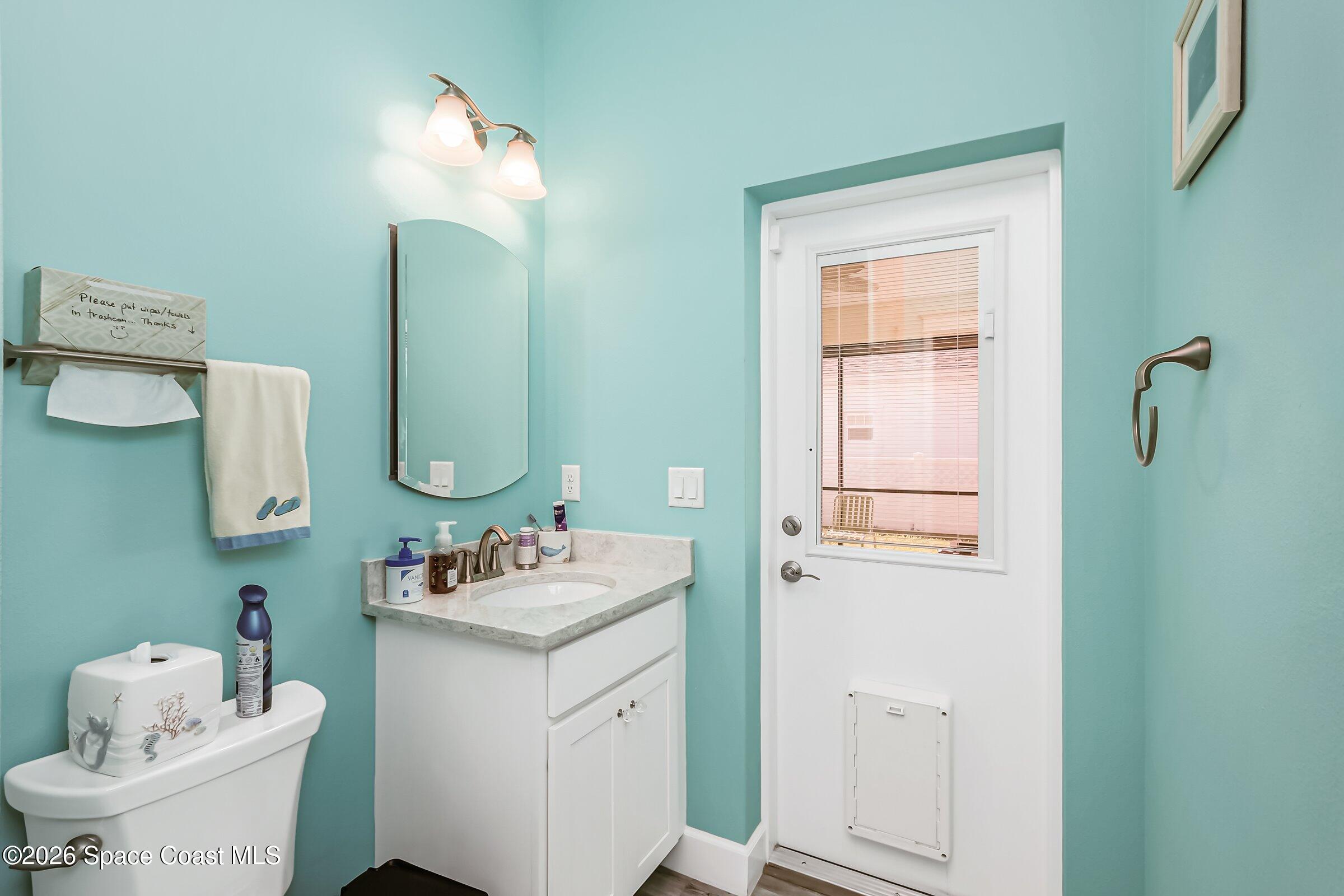 1399 Tullagee Avenue Melbourne, FL 32940 - Photo 25 of 53 a bathroom with a sink vanity tub and toilet