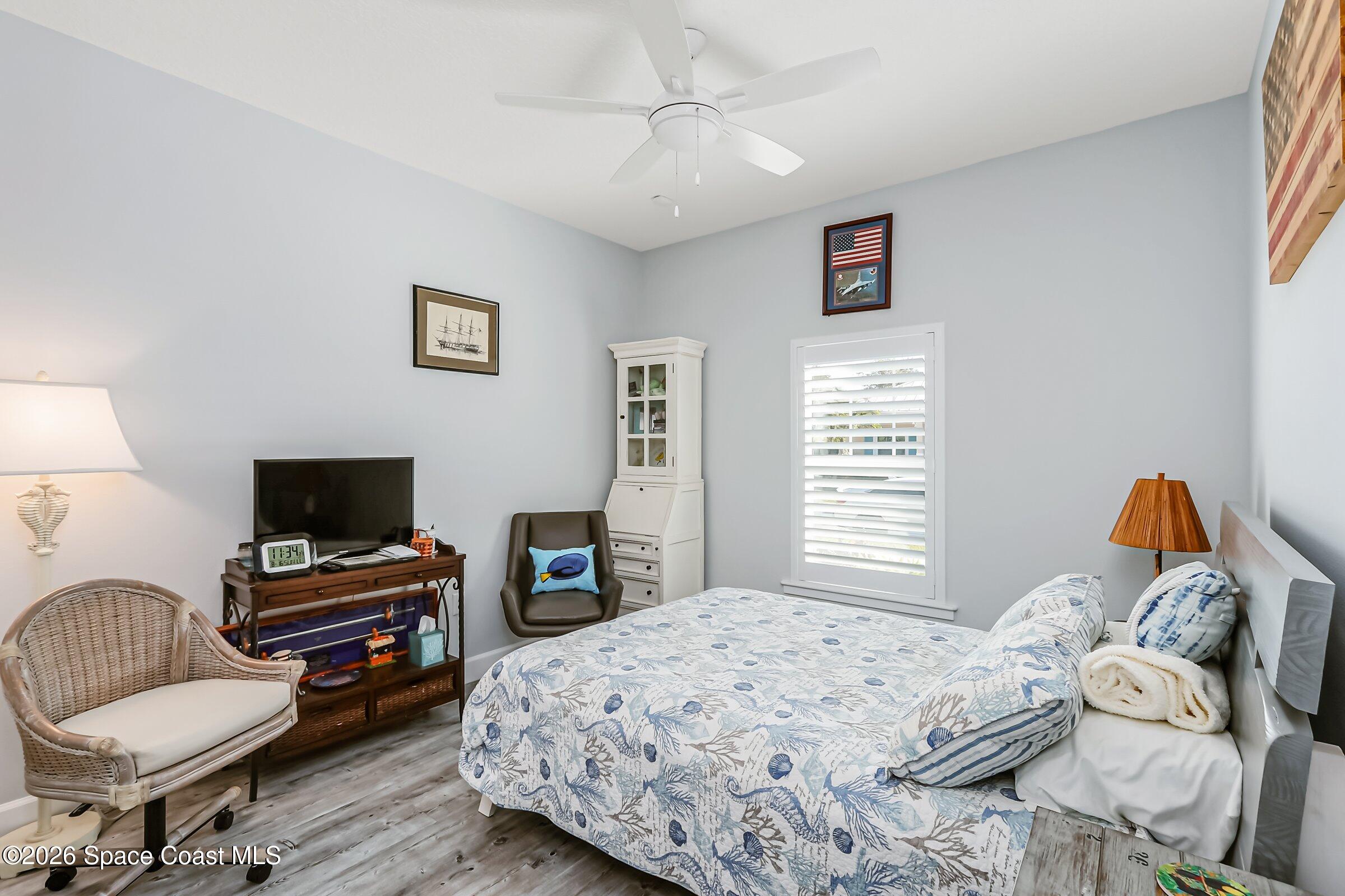 1399 Tullagee Avenue Melbourne, FL 32940 - Photo 26 of 53 a bedroom with a bed and a couch