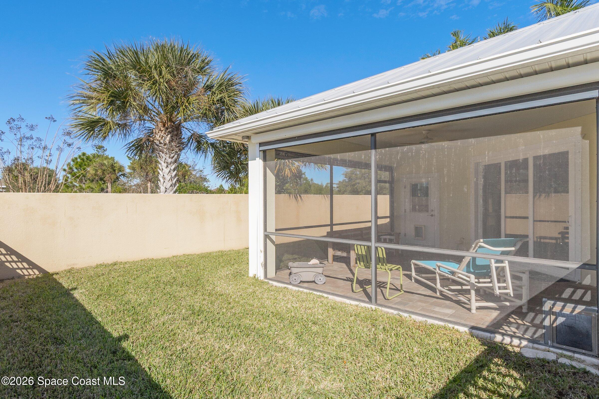 1399 Tullagee Avenue Melbourne, FL 32940 - Photo 33 of 53 a backyard with table and chairs and potted plants