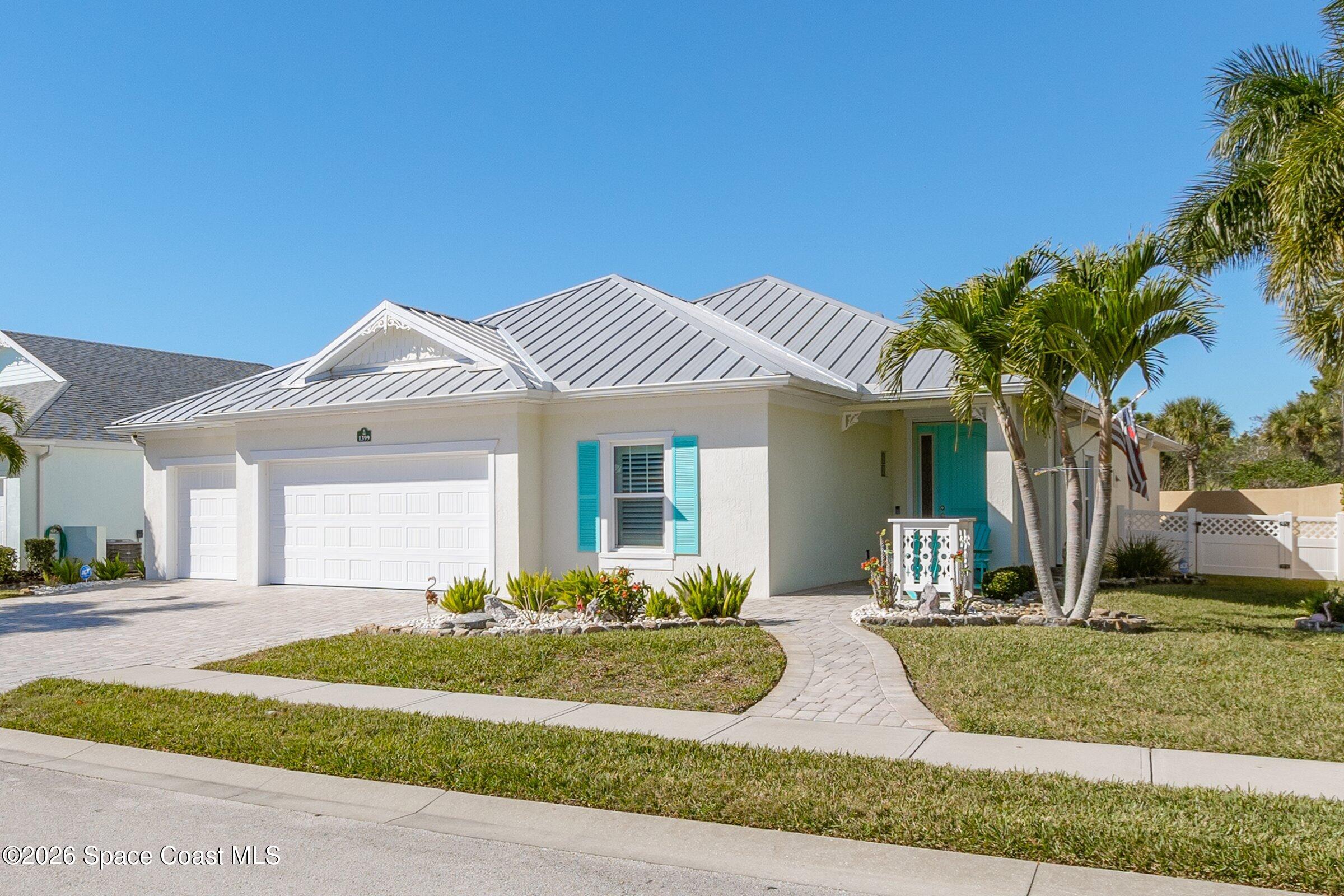 1399 Tullagee Avenue Melbourne, FL 32940 - Photo 4 of 53 a front view of a house with a yard and potted plants