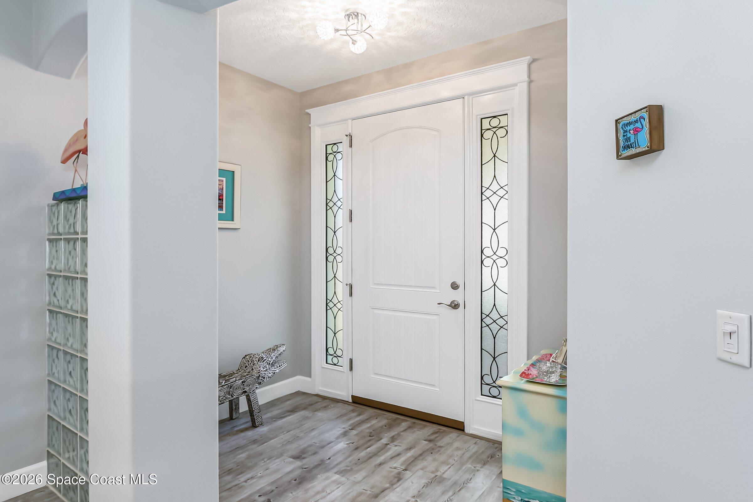 1399 Tullagee Avenue Melbourne, FL 32940 - Photo 7 of 53 an empty room with wooden floor and a window