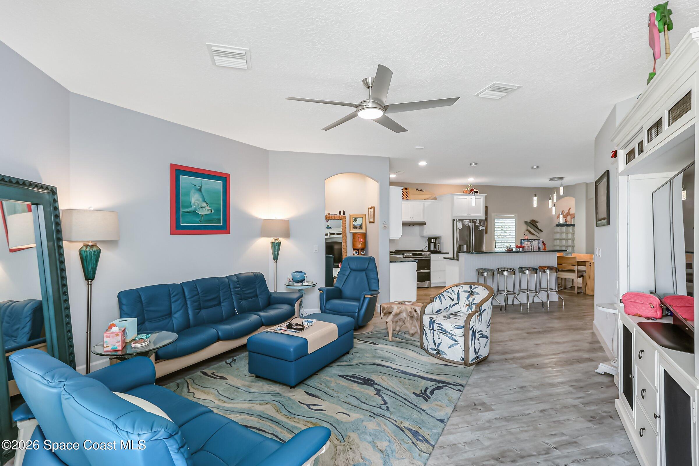 1399 Tullagee Avenue Melbourne, FL 32940 - Photo 9 of 53 a living room with furniture and a chandelier