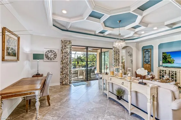 a large white kitchen with a table and chairs