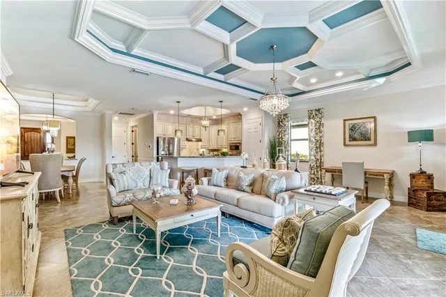 a living room with furniture and a chandelier