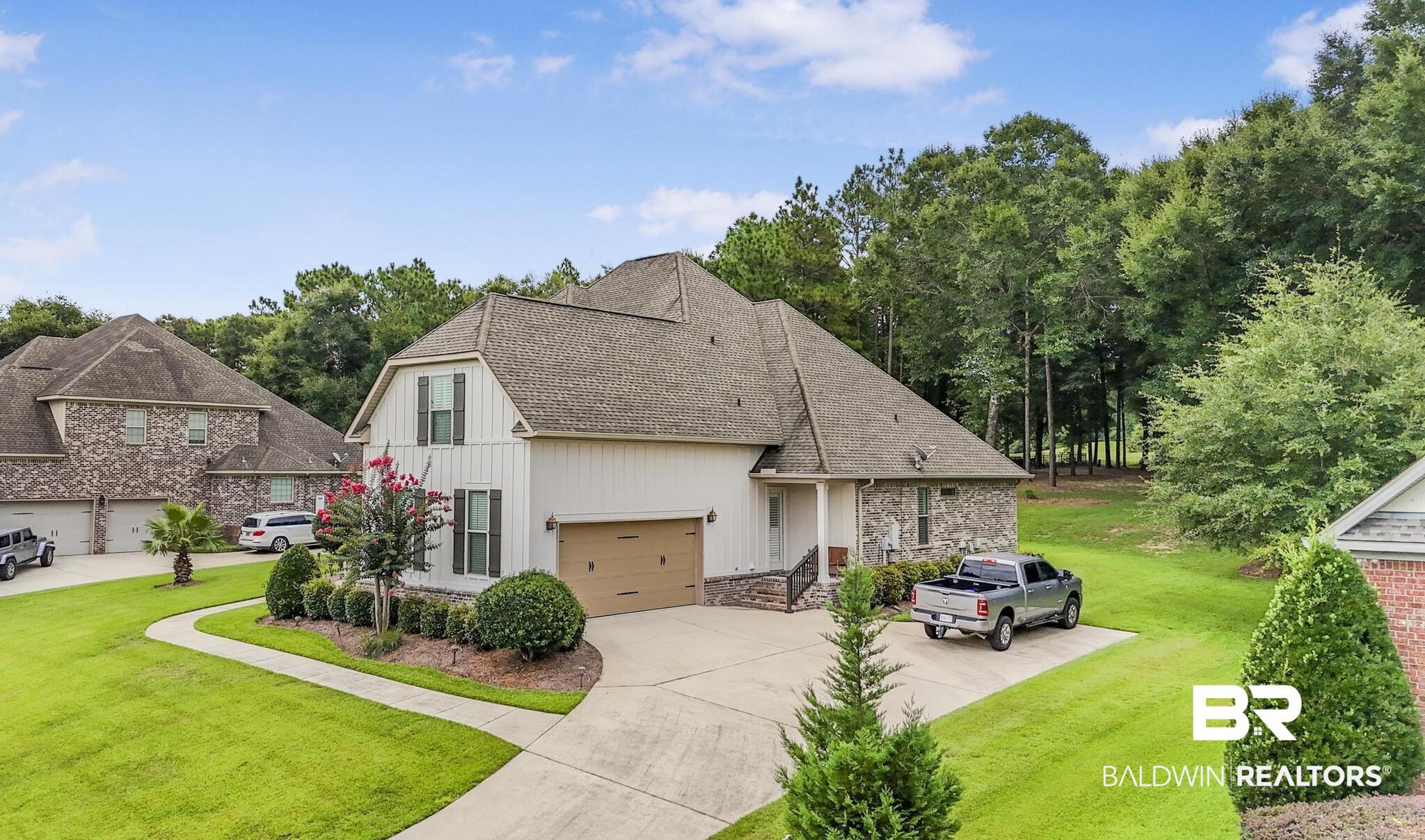 29949 Dolive Ridge Daphne, AL 36527 - Photo 49 of 55 Contemporary residence featuring white vertical siding, stone accents, and a multi-level shingle roof