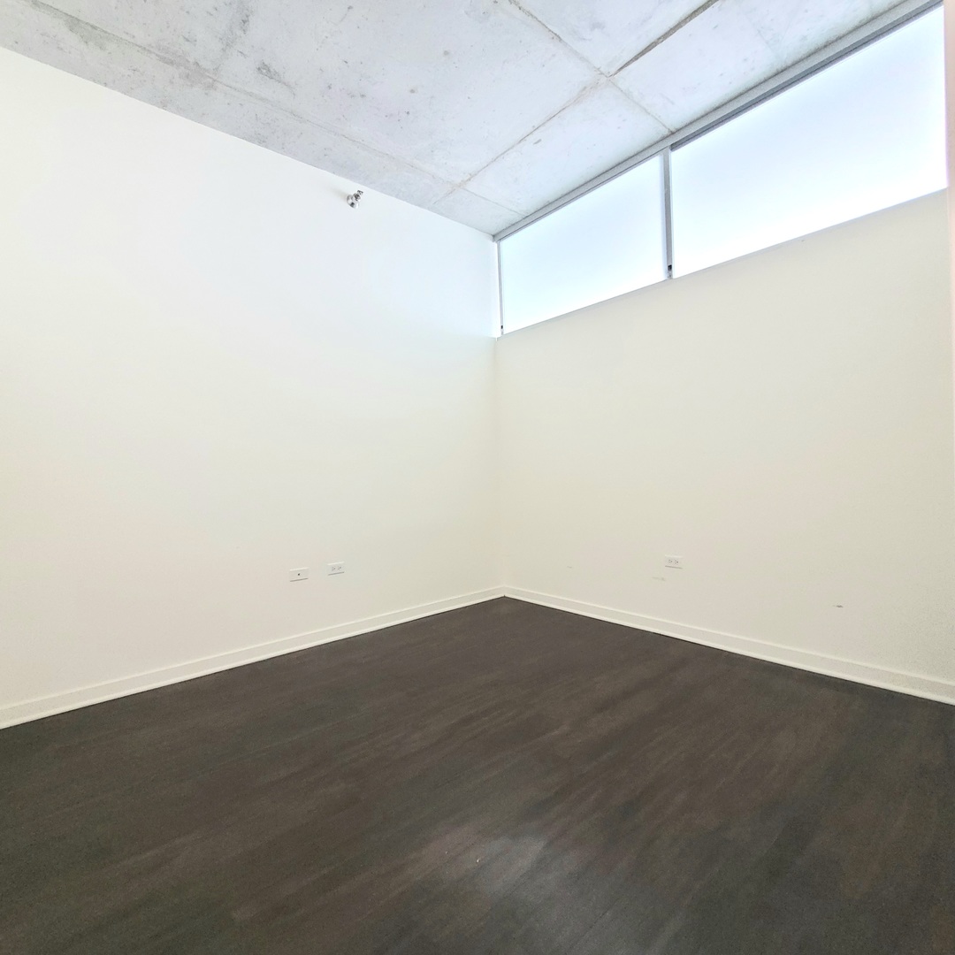 Undisclosed Address Chicago, IL 60607 - Photo 13 of 26 an empty room with wooden floor