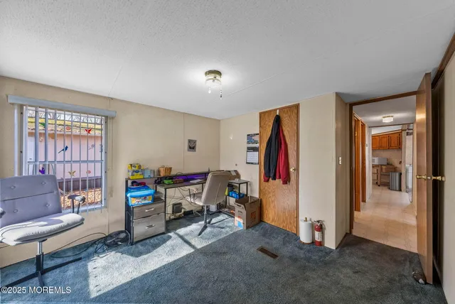 a view of a livingroom with furniture and workspace