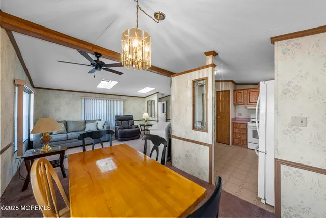 a view of kitchen with stainless steel appliances furniture refrigerator and wooden floor