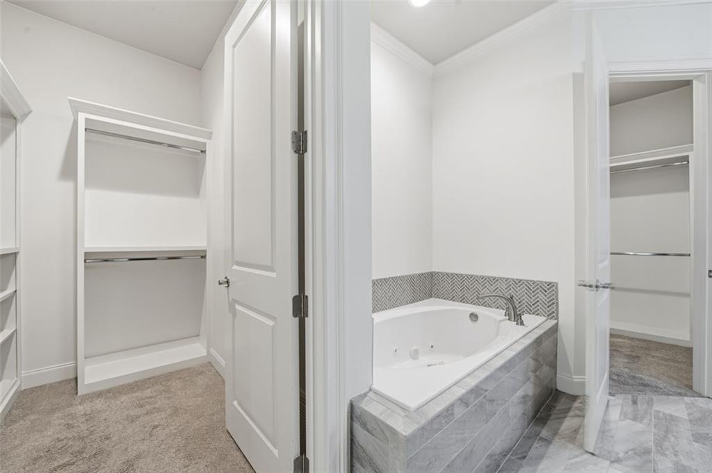 337 Rosshandler Road Suwanee, GA 30024 - Photo 23 of 45 a bathroom with a bathtub and a shower