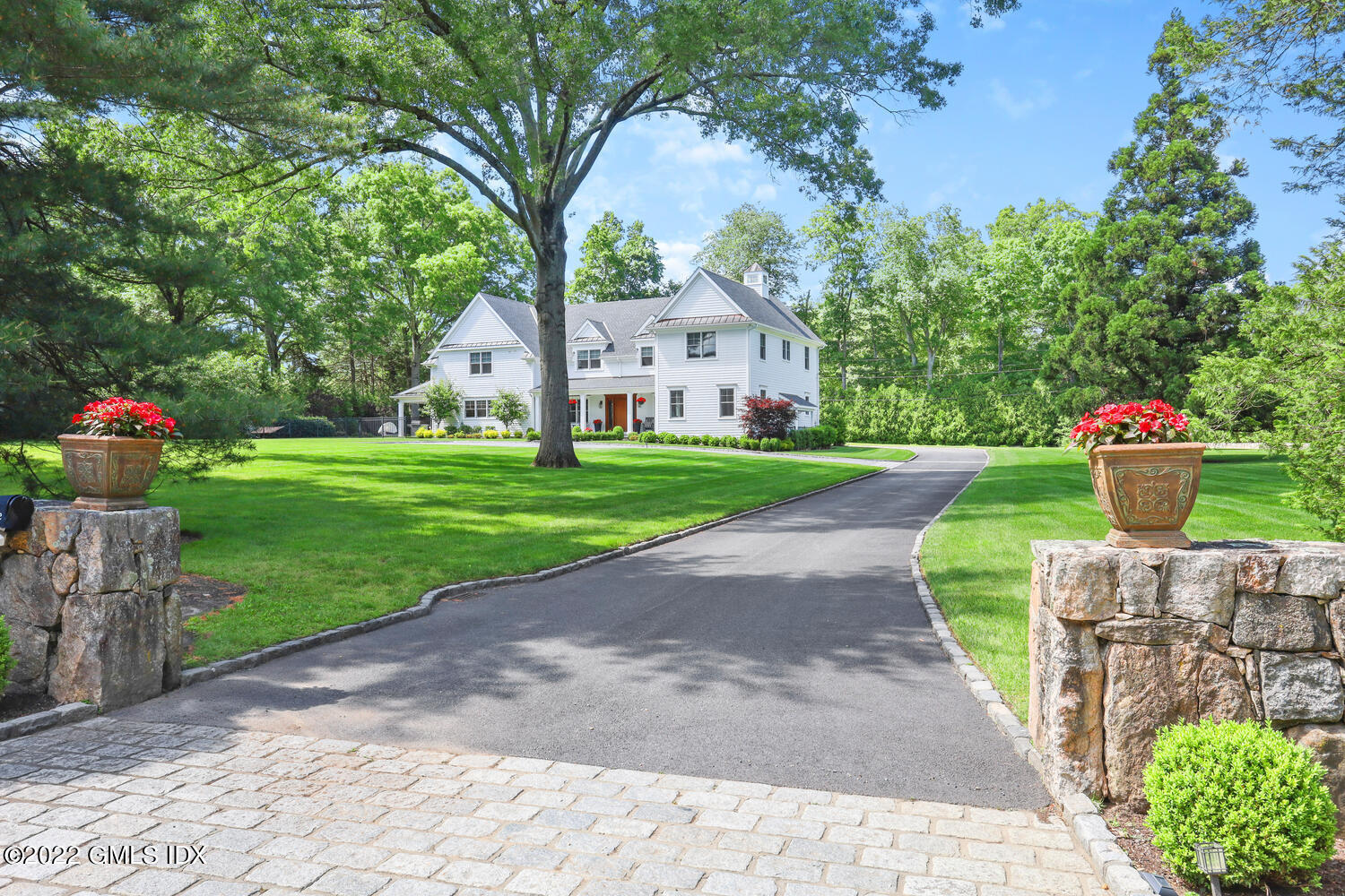 2 Loch Lane Greenwich, CT 06830 - Photo 1 of 64 a front view of a house with a yard and a garden