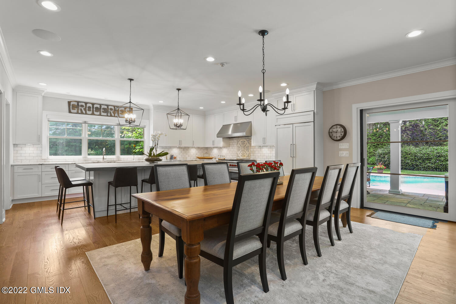 2 Loch Lane Greenwich, CT 06830 - Photo 16 of 64 a dining room with furniture a chandelier and wooden floor