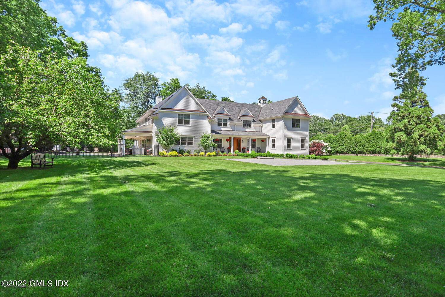 2 Loch Lane Greenwich, CT 06830 - Photo 2 of 64 a front view of a house with a garden