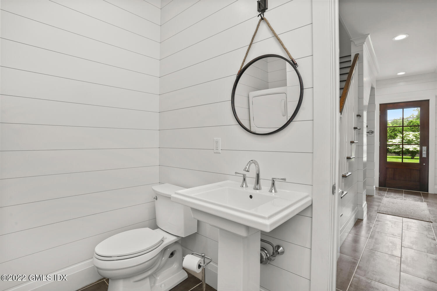 2 Loch Lane Greenwich, CT 06830 - Photo 26 of 64 a bathroom with a toilet sink and mirror