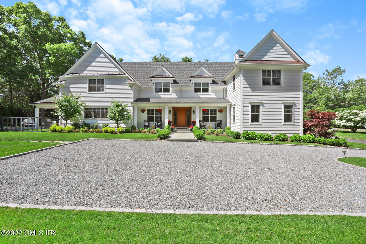 2 Loch Lane Greenwich, CT 06830 - Photo 4 of 64 a front view of a house with a yard and garage