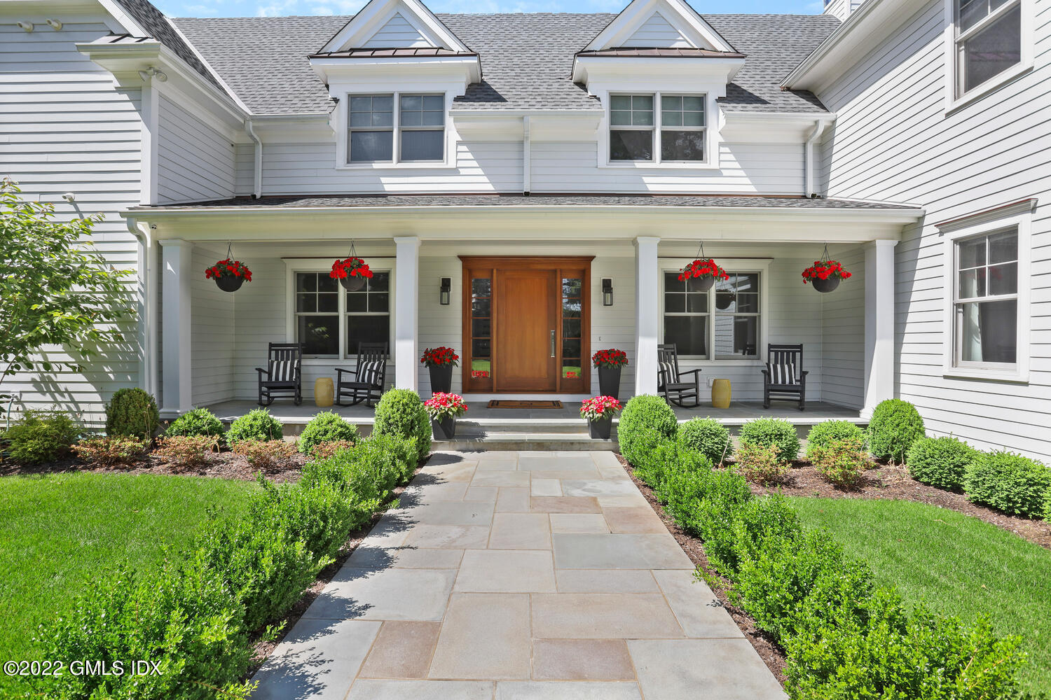 2 Loch Lane Greenwich, CT 06830 - Photo 5 of 64 front view of a brick house with a small yard
