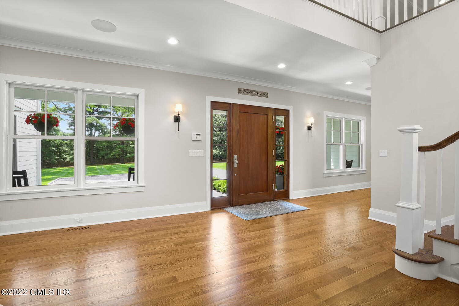 2 Loch Lane Greenwich, CT 06830 - Photo 7 of 64 a view of a big room with wooden floor and windows