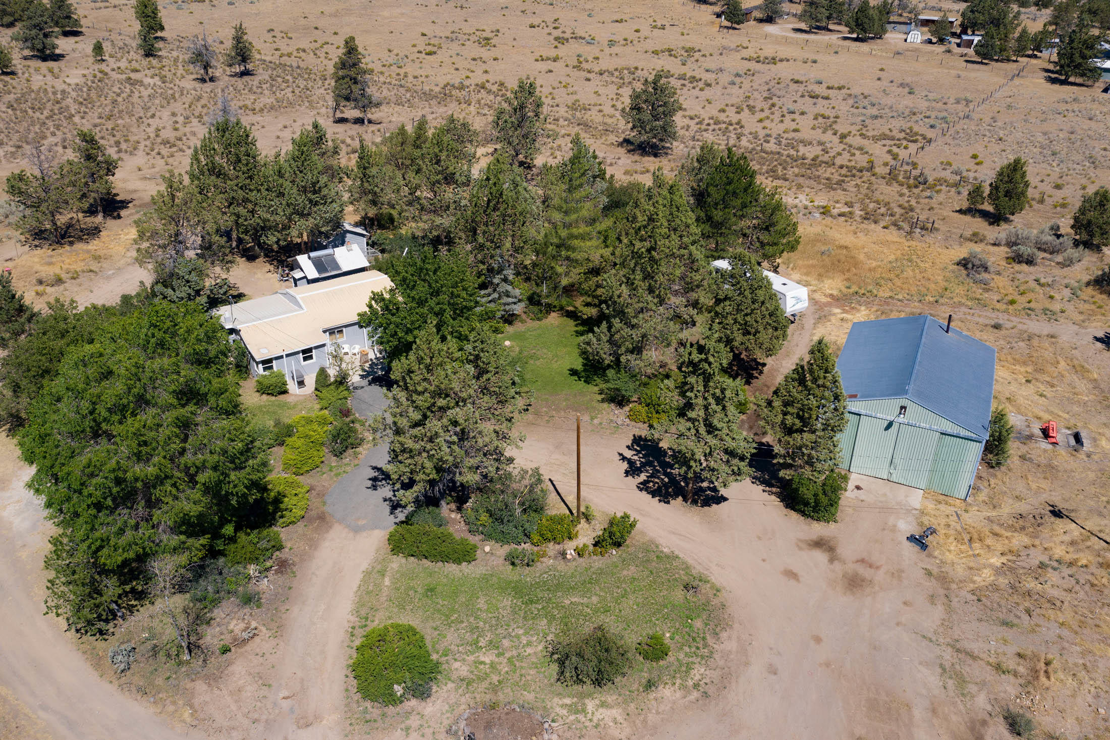 Overhead view of circular driveway, shop, home, buildings