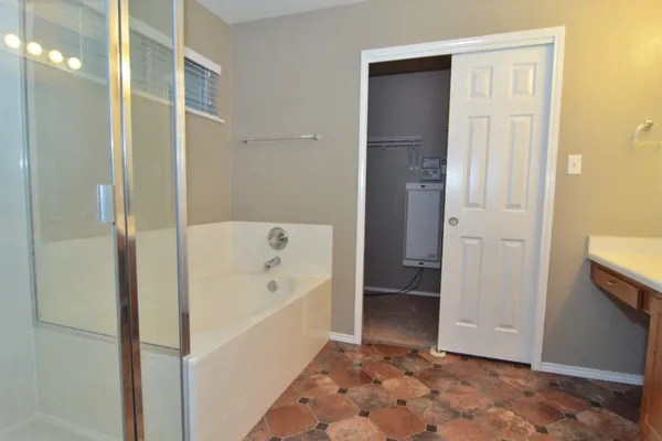 a bathroom with a bathtub and a shower
