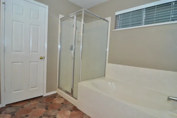 a bathroom with a bathtub and a shower