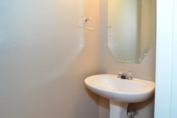 a bathroom with a sink a mirror and a toilet