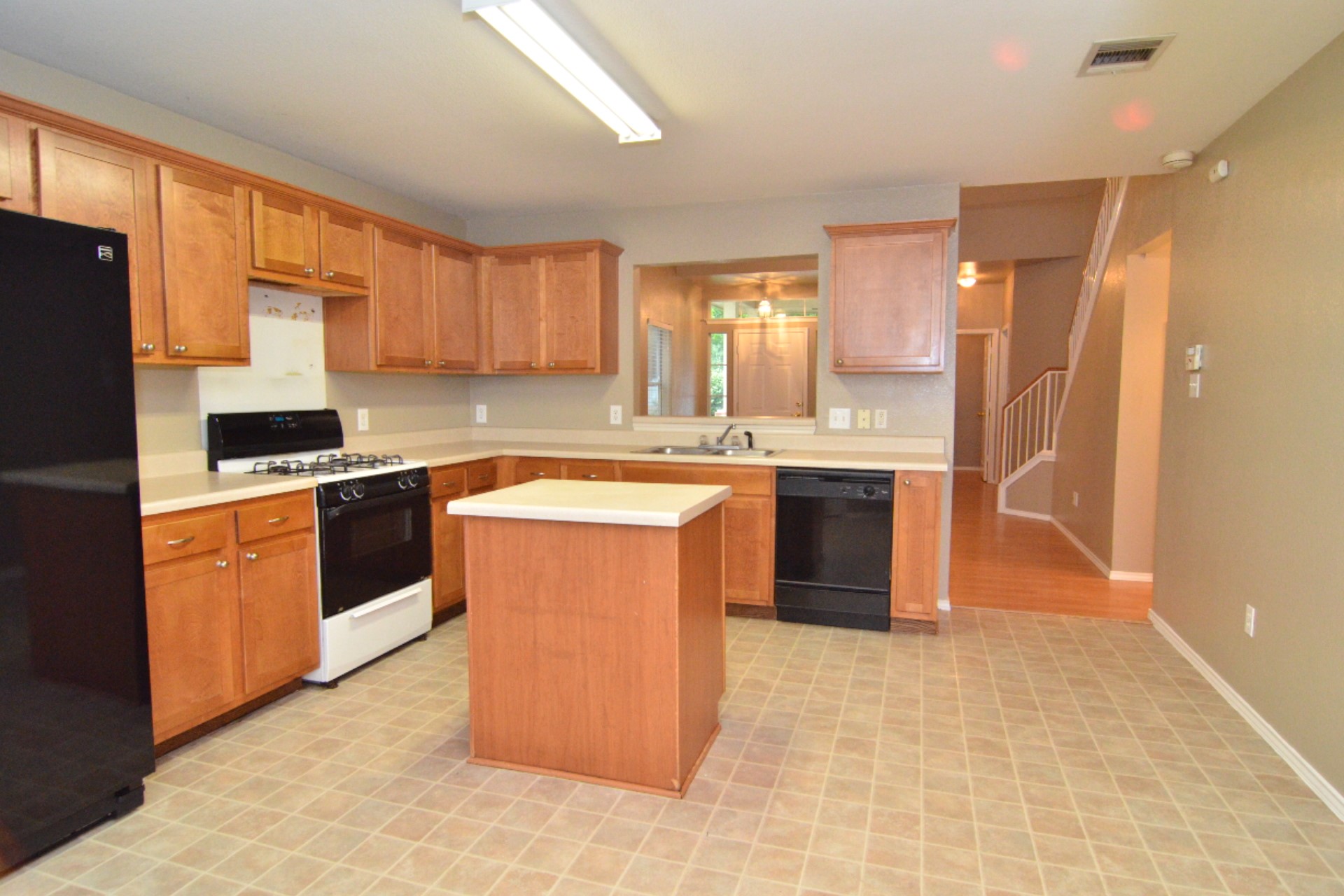 316 Strawn Kyle, TX 78640 - Photo 20 of 34 a kitchen with stainless steel appliances granite countertop a stove a sink dishwasher a refrigerator and cabinets with wooden floor