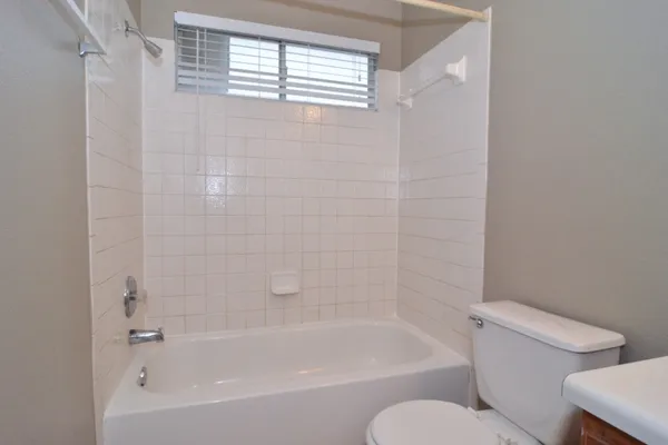 a white bath tub sitting next to a white toilet