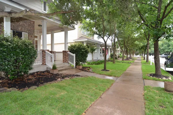 a front view of a house with a yard and fountain