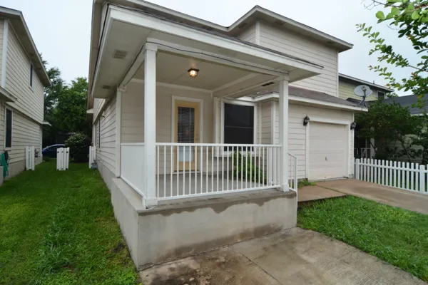 a front view of a house with a garden and porch